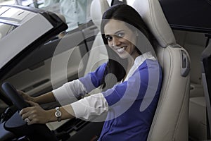 Portrait of smiling woman sitting in front seat of car