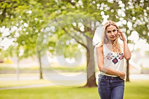 Portrait of smiling woman standing on grass