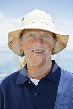 Portrait of smiling woman wearing hat on yacht