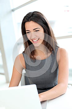 Portrait of smiling woman working on laptop