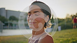 Portrait smiling yoga woman posing sunlight park at morning. Lady looking camera