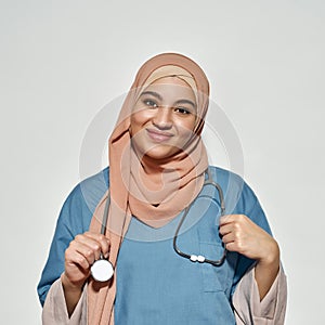 Portrait of smiling young arabian woman in doctor outfit