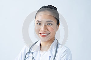 Portrait of smiling young asian female doctor in a background for your text