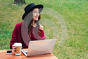 Portrait of a smiling young asian girl using laptop computer