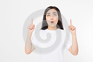 Portrait of smiling young asian woman wearing summer t shirt pointing at copy space by finger isolated on white
