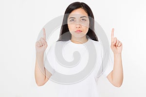 Portrait of smiling young asian woman wearing summer t shirt pointing at copy space by finger isolated on white template and blank