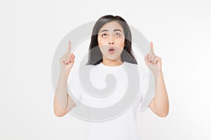 Portrait of smiling young asian woman wearing summer t shirt pointing at copy space by finger isolated on white template and blank