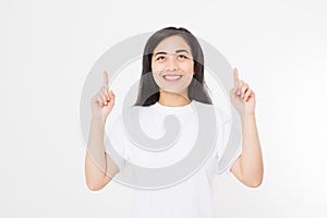 Portrait of smiling young asian woman wearing summer t shirt pointing at copy space by finger isolated on white template t shirt