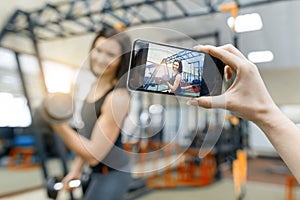 Portrait of smiling young beautiful caucasian fitness woman in gym, female looking at camera. Fitness, sport, training, people,