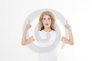 Portrait of smiling young blonde caucasian woman wearing summer t shirt pointing at copy space by finger isolated on white