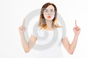 Portrait of smiling young blonde caucasian woman wearing summer t shirt pointing at copy space by finger isolated on white