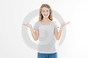 Portrait of smiling young blonde caucasian woman wearing summer t shirt pointing at copy space by hands isolated on white template