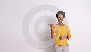 Portrait of smiling young businesswoman aiming at copy space for marketing on white background