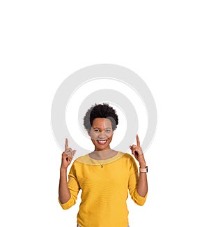 Portrait of smiling young businesswoman pointing upwards and advertising on white background