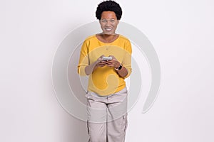 Portrait of smiling young businesswoman using social media over mobile phone on white background