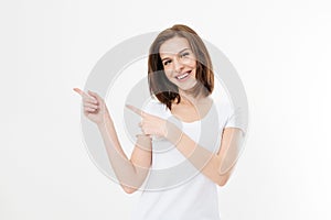 Portrait of smiling young caucasian woman wearing summer t shirt pointing at copy space by finger isolated on white template