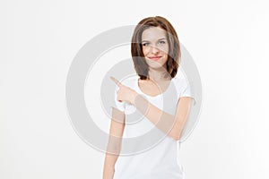 Portrait of smiling young caucasian woman wearing summer t shirt pointing at copy space by finger isolated on white template