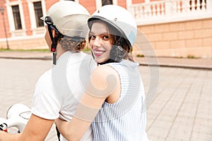 Portrait of a smiling young couple in helmets
