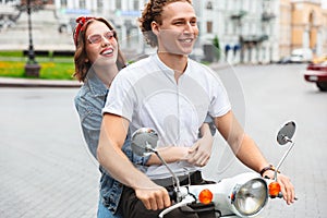 Portrait of a smiling young couple riding on a motorbike