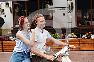 Portrait of a smiling young couple riding on a motorbike