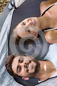 portrait smiling young couple in tent