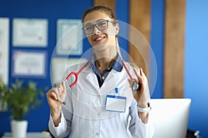 Portrait of smiling young female doctor in glasses