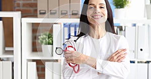 Portrait of smiling young female doctor holding stethoscope