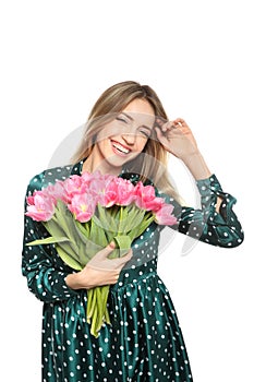 Portrait of smiling young girl with beautiful tulips on white. International Women`s Day