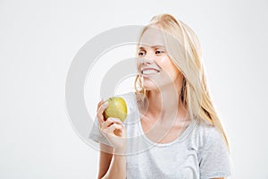 Portrait of a smiling young girl holding green apple