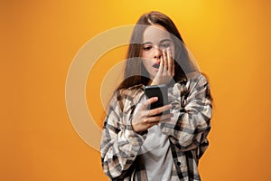 Portrait of a smiling young girl using smartphone