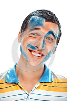 Portrait of a smiling young handsome guy with paint on his face