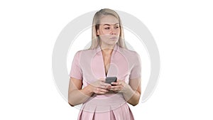 Portrait of smiling young lady reading text message on her mobile phone on white background.