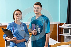 Portrait of smiling young male and female doctor in uniform with