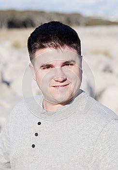 Portrait of Smiling Young Man at the Beach