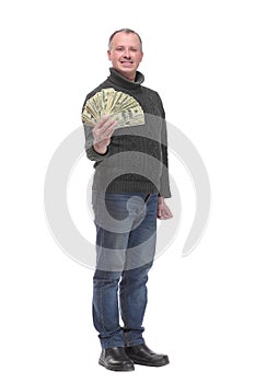 Portrait of smiling young man holding fanned US paper currency