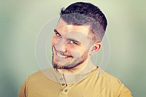 Portrait of a smiling young man nervously