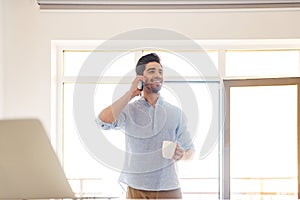 Portrait of a smiling young man talking on mobile phone