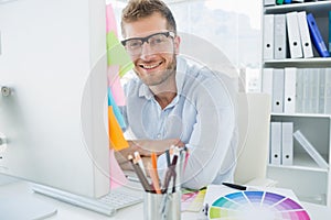 Portrait of a smiling young man using computer