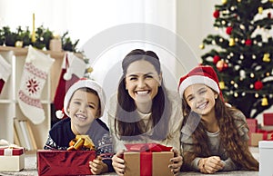 Smiling mother and kids celebrate New Year together