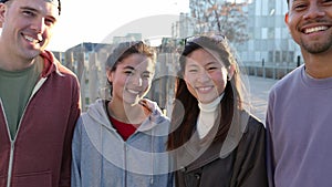 Portrait of smiling young multi-ethnic friends standing together outdoors