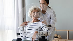 Portrait of smiling young professional therapist with disabled patient.