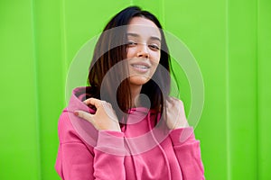 Portrait of smiling young teenage girl looking to the camera during walking outside. Outdoor portrait of beautiful female has