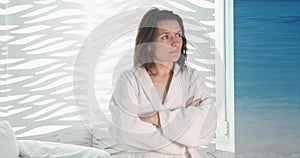 Portrait of smiling young woman in bathrobe