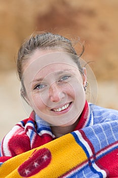 Portrait of smiling young woman on beach in cloudy weather