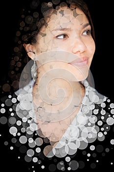 A portrait of a smiling young woman combined with translucent circles in a double exposure technique.