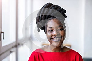 Portrait of a smiling young woman indoors