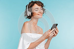 Portrait of a smiling young woman listening to music