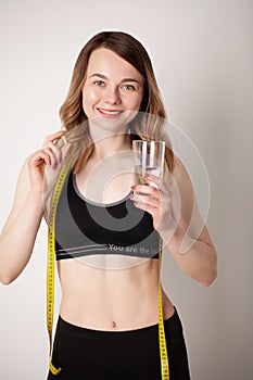 Portrait of smiling young woman with Omega 3 fish oil capsule