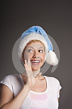 Portrait of smiling young woman in Santa hat