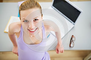 Portrait of smiling young woman studying in kitchen